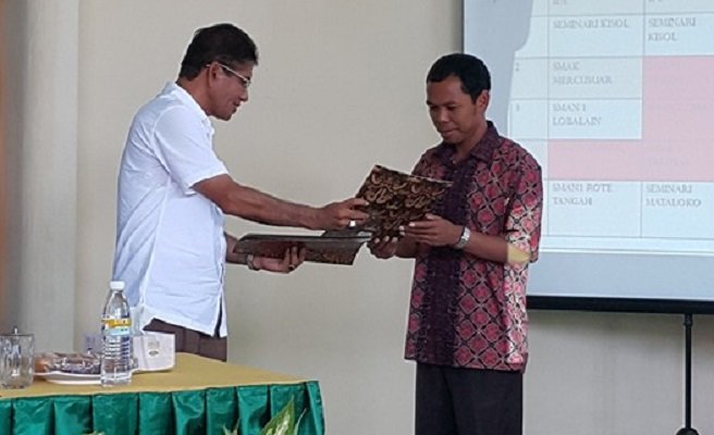 Kepala Dinas Pendidikan, Pemuda dan Olahraga Provinsi Nusa Tenggara Timur menyerahkan perngharaan kepada Kepala Sekolah Seminari Pius XII Kisol